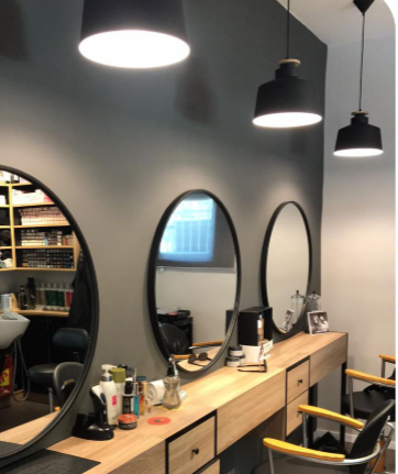 Professional unisex hair salon with expert stylists offering modern haircuts, grooming, and styling services for men and women